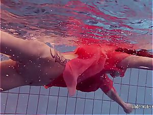 redhead dancing in the pool
